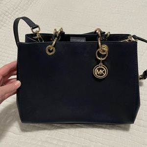 Navy Michael Kors handbag with gold accents. Never used.